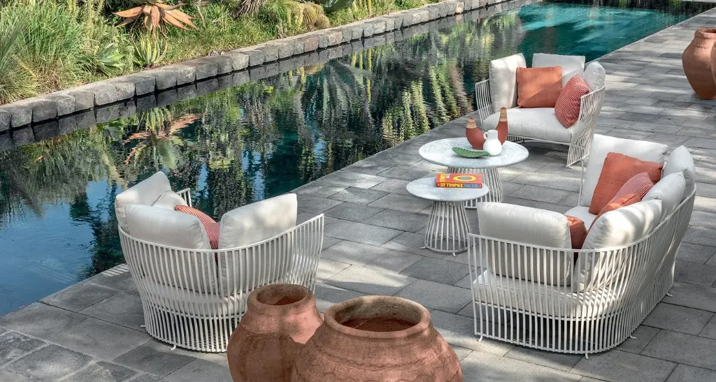 poolside bliss: outdoor lounge chairs and coffee tables.
